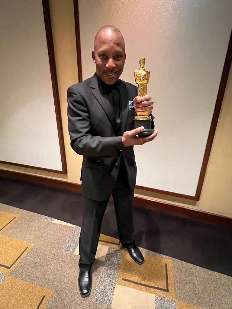 Mr. Vincent Womack holding an Oscar Award